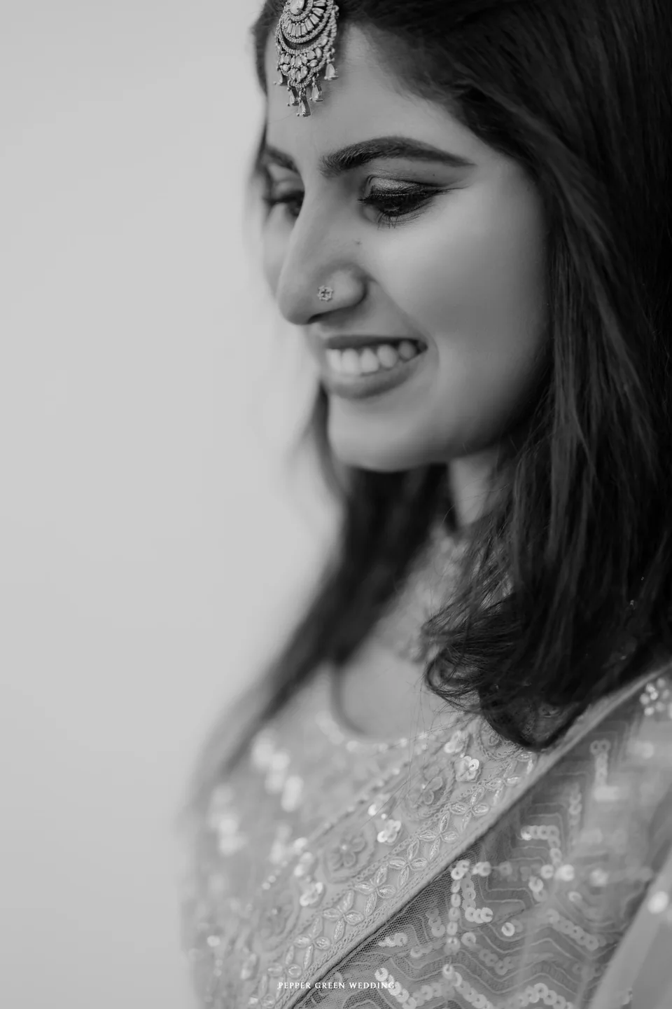 Sivani smiling, in an elegant black-and-white portrait